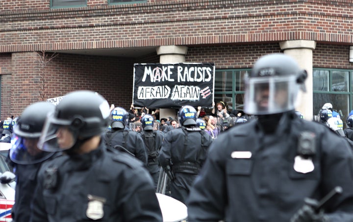 Demonstrators are surrounded by riot police during a protest at the American Health Care Association in Washington, D.C., on Jan. 20, 2017. 