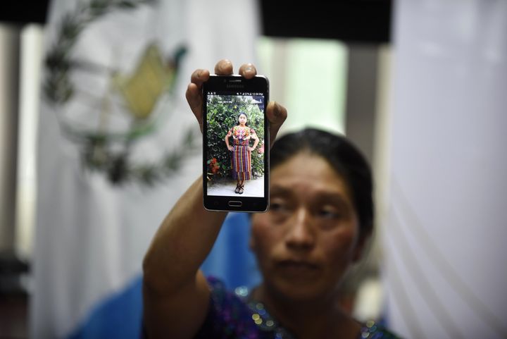 Dominga Vicente shows a photo of her niece Claudia Gómez during a press conference in Guatemala City on May 25, 2018. The family demanded justice and called for her body to be sent back home so they could bury her in her native village.