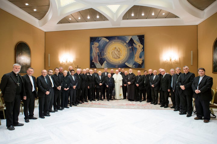 Pope Francis poses with Chilean bishops after a meeting at the Vatican on May 17, 2018. More than 30 Chilean bishops submitte