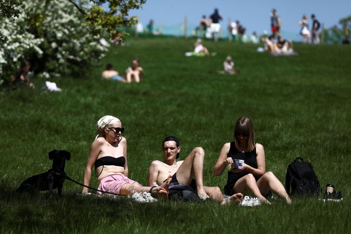 People enjoy the sunshine on Primrose Hill in London last month
