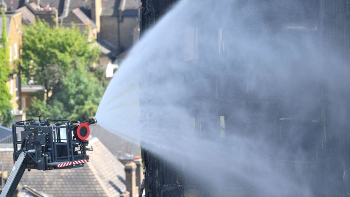 Firefighters spray water after a fire engulfed the 24-storey Grenfell Tower in west London.