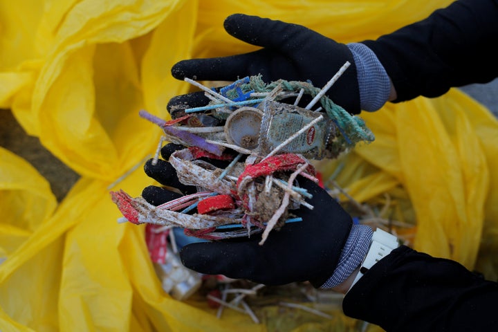 A volunteer shows plastics from a garbage collection on the Atlantic coast in Rota Spain, June 2018.