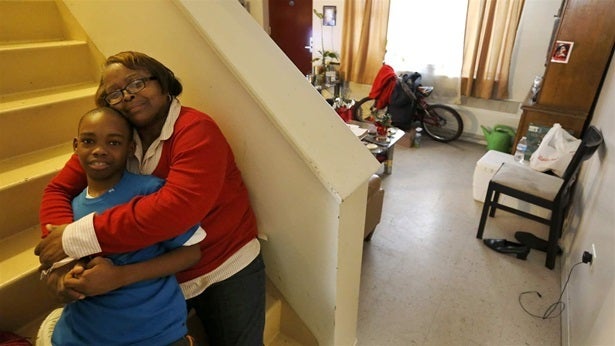 Debra Aldridge poses with her grandson, Mario Hendricks, at her home on Chicago’s South Side. Nationwide, millions of grandparents are raising grandchildren. A new federal law overhauling the foster care system provides more support for grandparents and other relatives raising children.