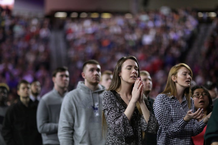 Thousands of students, supporters and invited guests sing Christian praise songs before then-candidate Donald Trump speaks at Liberty University on Jan. 8, 2016.