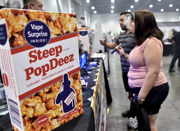 Attendees at the Vape Summit 3 in Las Vegas sample vape pens alongside e-cigarette liquid packaged to look like Cracker Jack candy.