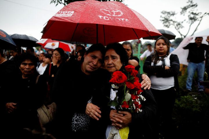 Mourners and relatives participate in the funeral of Juan Fernando Galindo, member of the National Coordinator for Disasters Reduction CONRED in Alotenango, Guatemala.