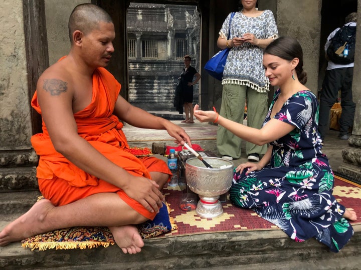 Getting a blessing from a Buddhist monk in Angkor Wat, Cambodia.