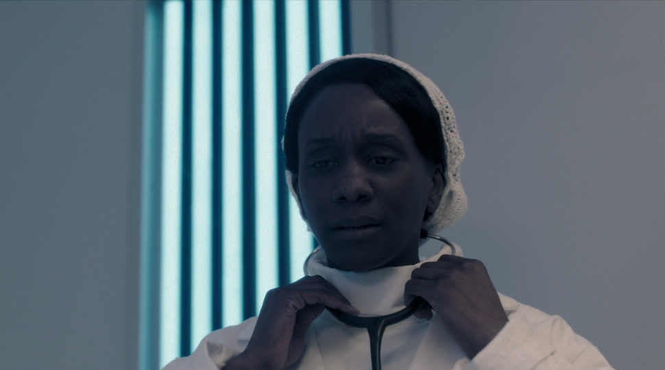 Doctor Hodgson (Karen Glave) is handed a stethoscope again.