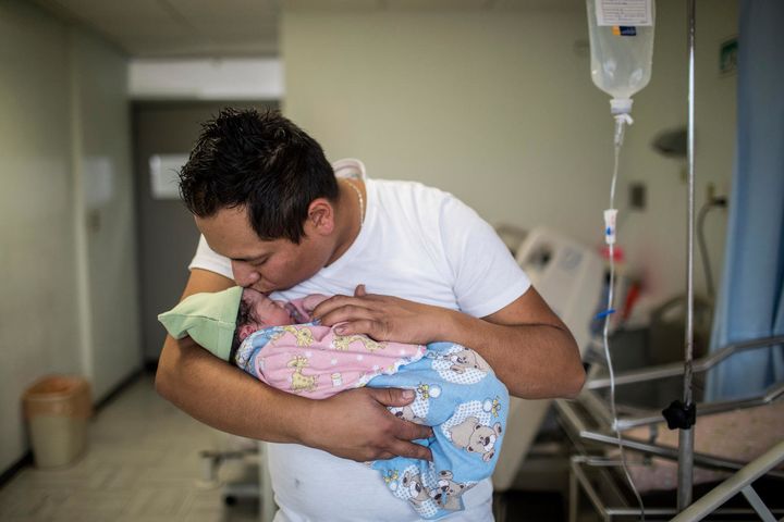 Yair Cruz, 26, holds his newborn baby girl and third child, Mia Gisele, at the Instituto Nacional de Perinatología hospital in Mexico City.