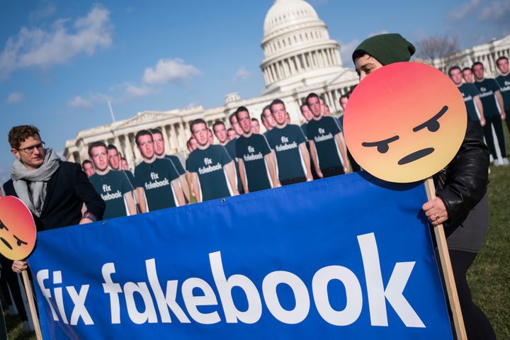 People protest ahead of Facebook CEO Mark Zuckerberg's testimony to Congress about privacy issues and political advertising in April 2018.