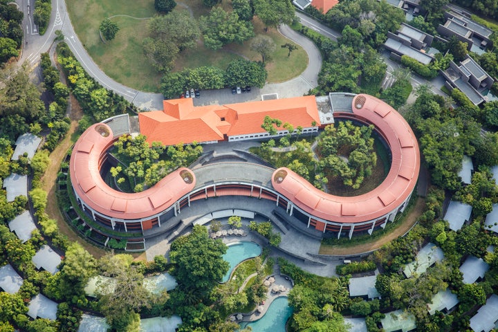Pictured in this aerial photograph, the Capella Hotel is a sprawling property atop a hill in Sentosa, an island off Singapore