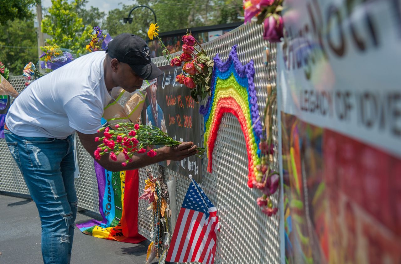 A visitor to the new interim Pulse nightclub memorial leaves flowers in Orlando Florida on June 4, 2018.
