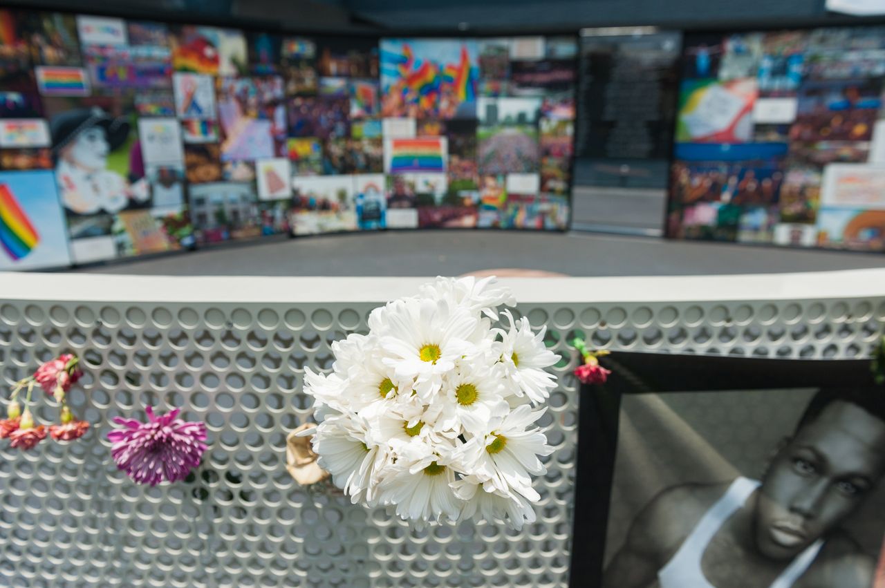 Flowers and signs hang in front of the new interim Pulse nightclub memorial in Orlando, Florida, on June 4, 2018.
