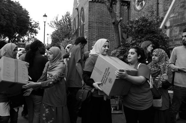 Volunteers passing donations to each other.