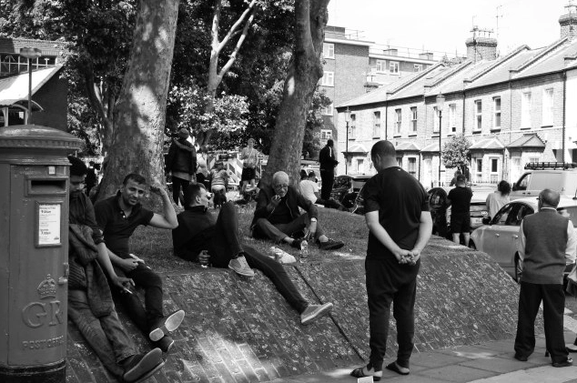 <strong>People sitting outside the Lancaster West Estate, where Grenfell Tower sits.</strong>