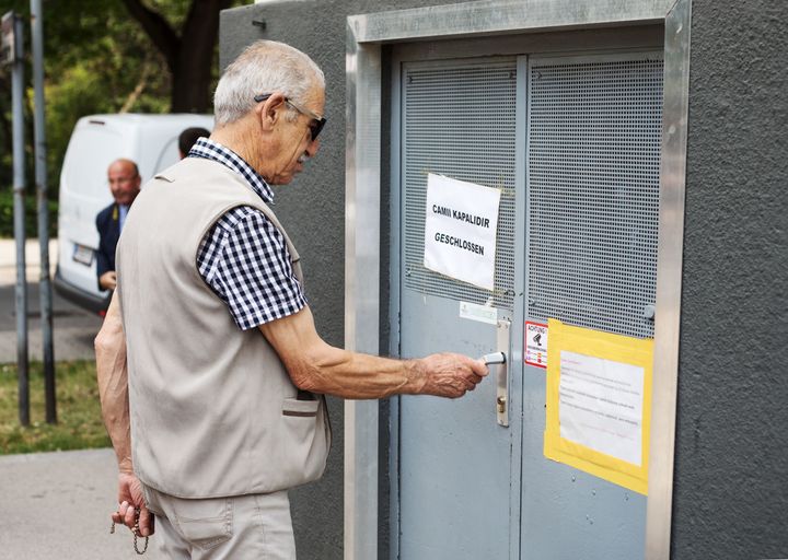 A community member tries to open the door of the 'Nizam-i Alem' mosque in Vienna's 10th district, on June 8, 2018. The mosque is one of seven that the Austrian government announced they would shut down.