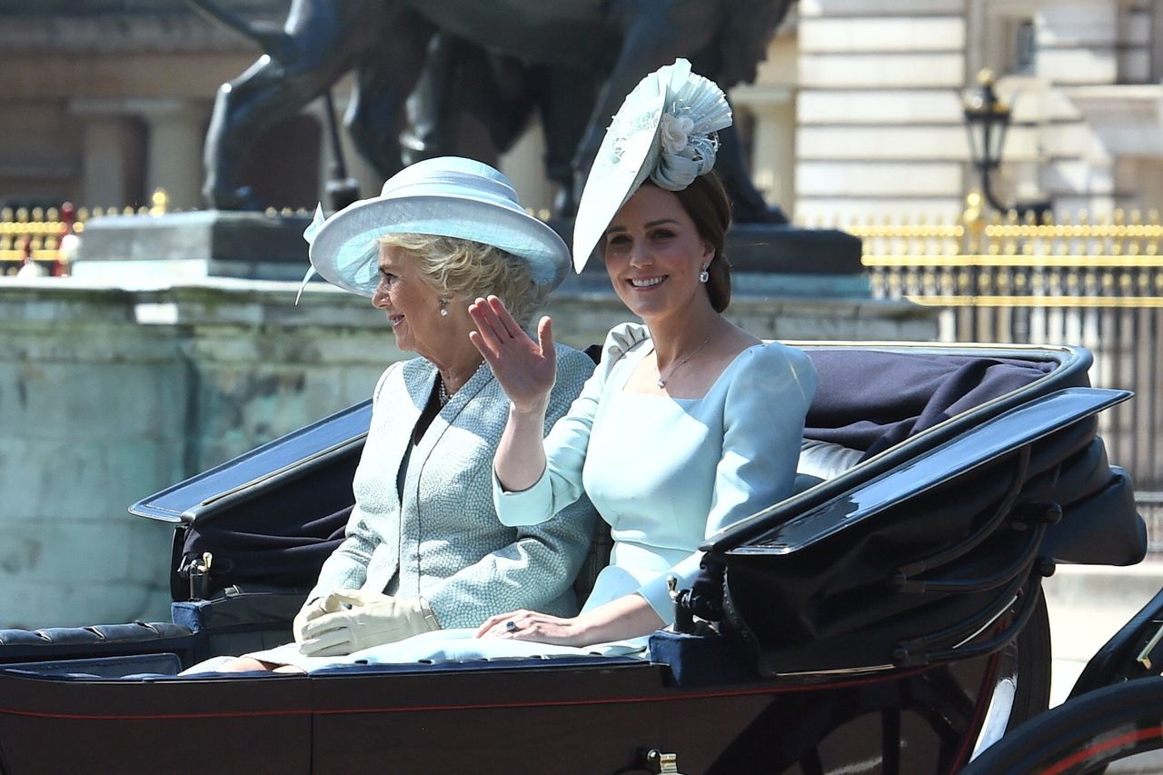 The Duchess of Cornwall (left) and the Duchess of Cambridge, ride in an carriage as it makes its way up The Mall from Buckingham Palace.