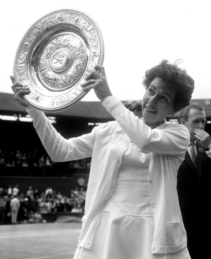 Bueno holds aloft the Wimbledon trophy for the third time after her women's singles win
