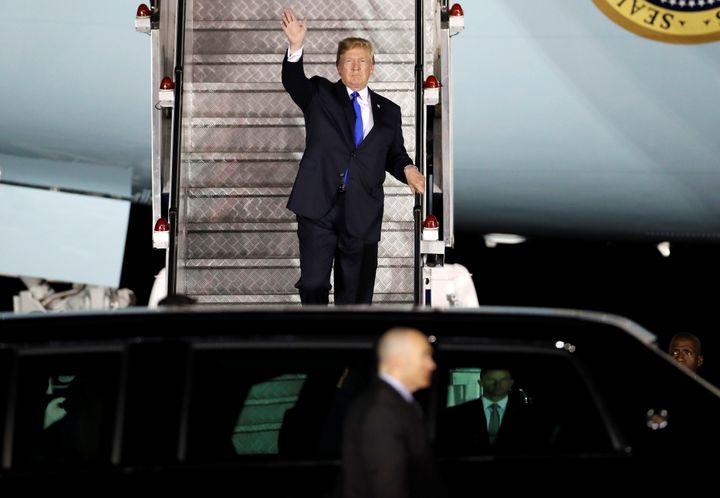 Donald Trump waves as he steps off his plane upon arriving in Singapore ahead of a summit with North Korean leader Kim Jong Un.