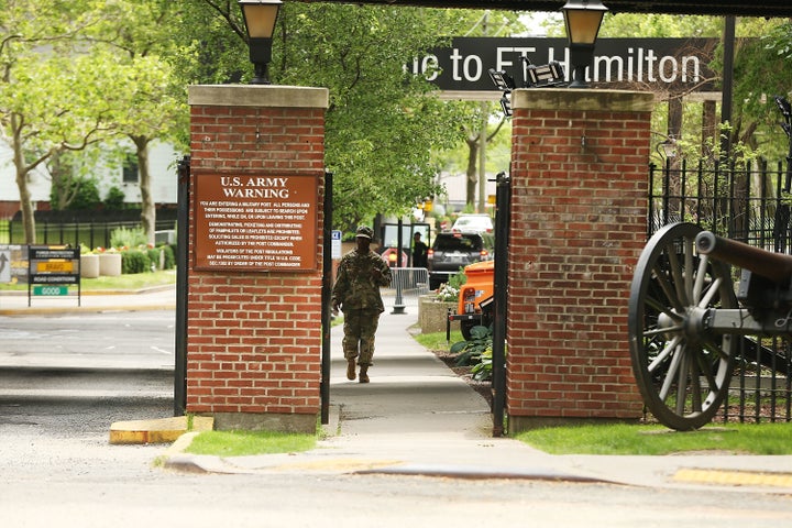 A soldier exits the Fort Hamilton military base in Brooklyn where a pizza delivery man was detained and questioned before bei