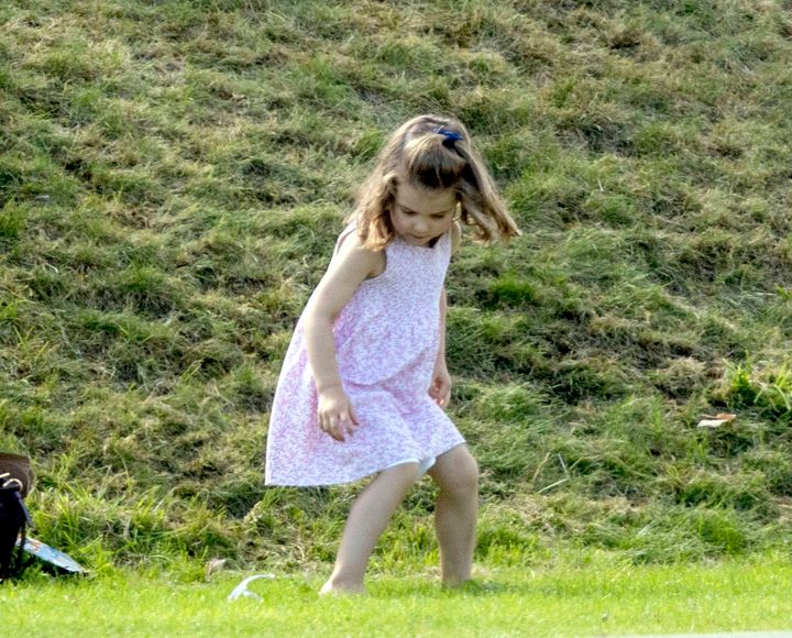 Princess Charlotte plays as her father, the Duke of Cambridge, takes part in the Maserati Royal Charity Polo Trophy.