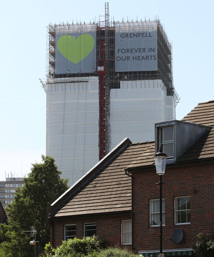 Banners are unveiled on the outside of Grenfell Tower ahead of the one-year anniversary
