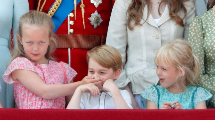 Savannah Phillips puts her hand over Prince George's mouth to keep her younger cousin quiet at Trooping the Color. The parade marks the official birthday of the Sovereign, even though the Queen's actual birthday is on April 21. 