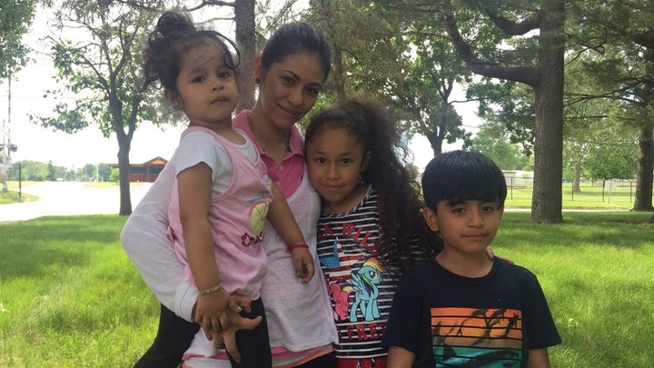 Julieta holds her nieces, Frida, 2, and Estrella, 8, and her son, Josue, 6, in Mount Pleasant, Iowa. The children’s fathers w
