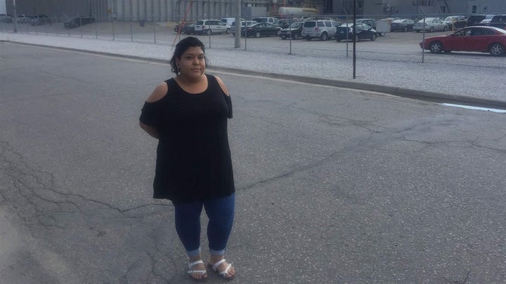 Maria Gonzalez stands in front of the Marshalltown, Iowa, meatpacking plant where her mother was detained in a raid by U.S. I