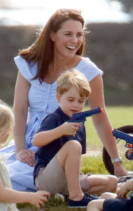 Catherine, Duchess of Cambridge looks on as Prince George of Cambridge plays with a toy gun whilst attending the Maserati Royal Charity Polo Trophy at the Beaufort Polo Club on 10 June 2018 in Gloucester, England.