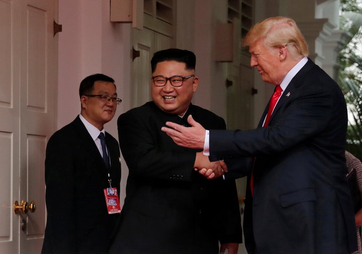 U.S. President Donald Trump shakes hands with North Korea's leader Kim Jong Un at the Capella Hotel on Sentosa island in Singapore on June 12, 2018.