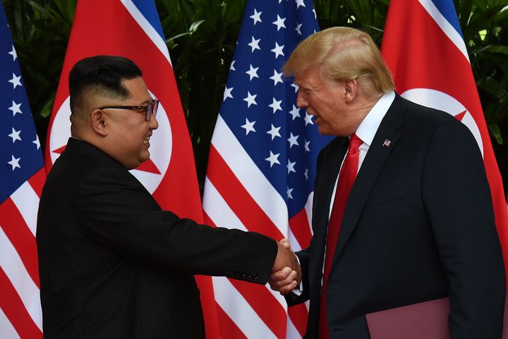 Kim looks happy during their historic 12 second handshake.