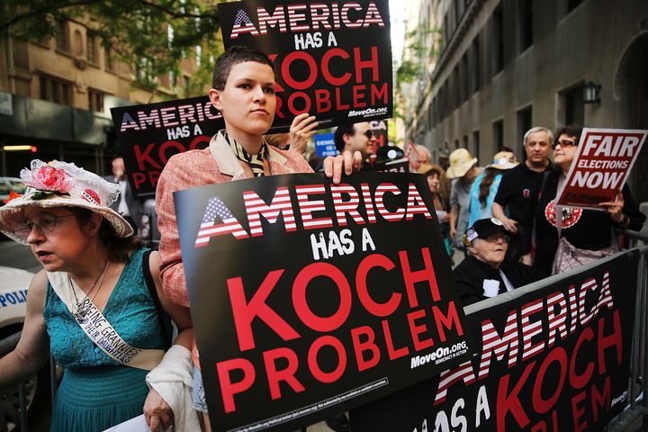 Activists hold a protests near the apartment of billionaire and Republican financier David Koch in June 2014. The Koch brothe