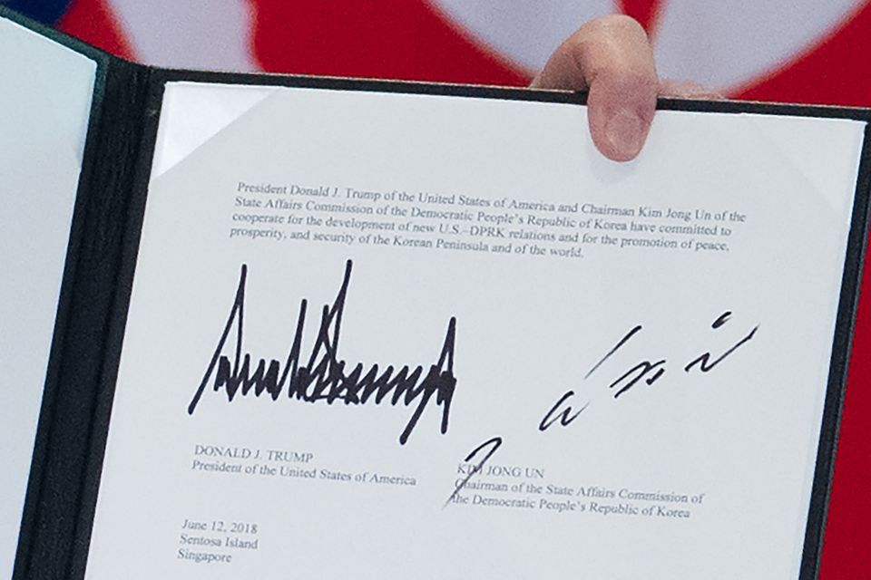 Let's make it official: The signatures of Trump and Kim are displayed following a signing ceremony 