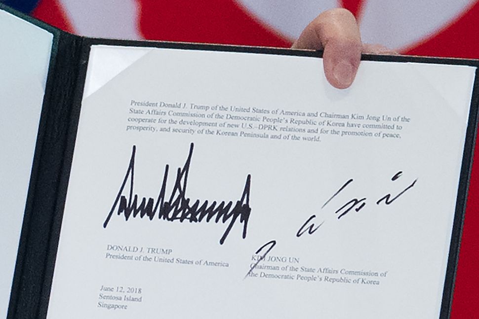 Let's make it official: The signatures of Trump and Kim are displayed following a signing ceremony 