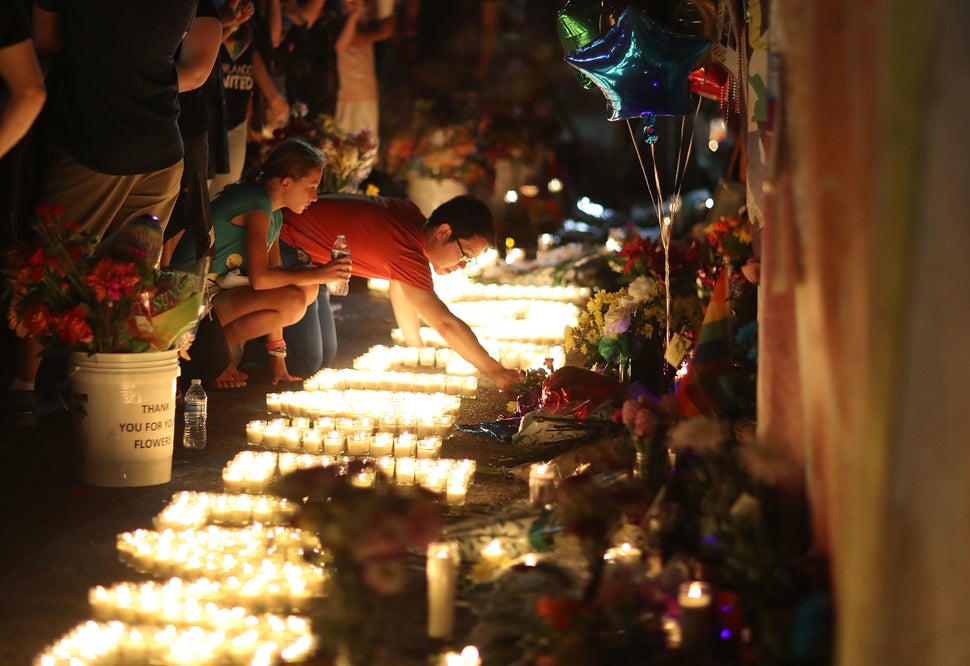 People visit a makeshift memorial outside Pulse on June 12, 2017, one year after a gunman killed 49 people there. S