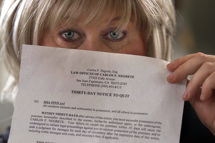 Mia Finn, 51, shows the eviction notice she received from the landlord. She is a flight attendant from San Juan Capistrano who is undergoing weekly chemotherapy treatment for stage 3 breast cancer and is being evicted from her apartment where she has lived for six years. (Photo by Irfan Khan/Los Angeles Times via Getty Images)