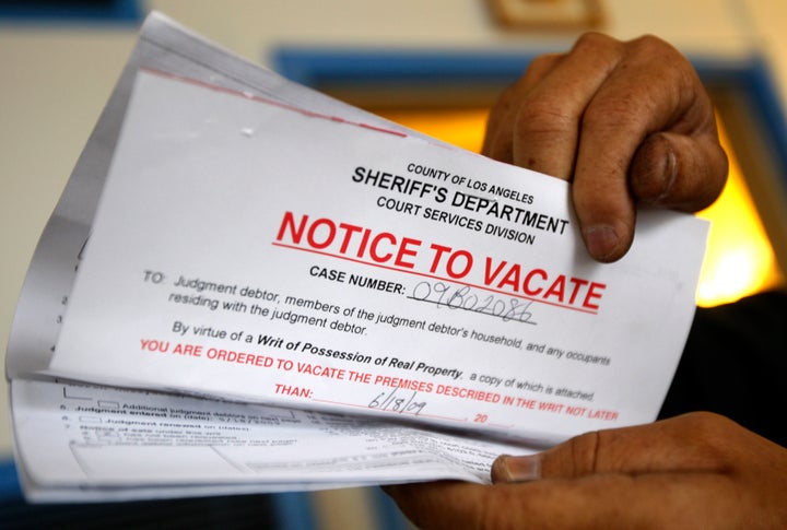 Vicente Oliveros holds up his eviction notice in Los Angeles, June 11, 2009. Oliveros was paying his $773 monthly rent and has lived in the apartment for 10 years, but had his trash services cut off and is now being evicted after the apartment building owner failed to pay the mortgage. 