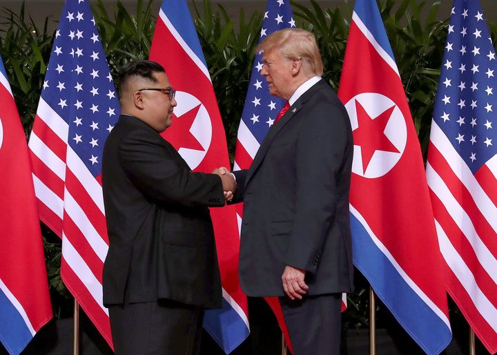 U.S. President Donald Trump shakes hands with North Korean leader Kim Jong Un at the Capella Hotel on Sentosa island in Singapore June 12, 2018.