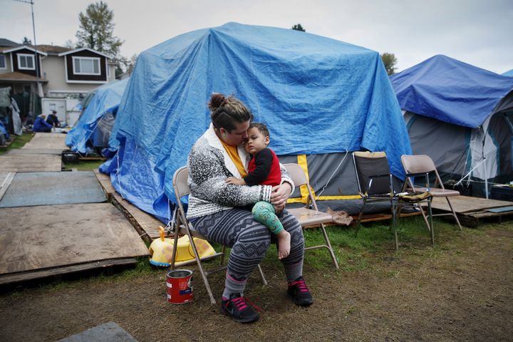 Kadee Ingram, 28, holds her son Sean, 2, at SHARE/WHEEL Tent City 3 outside Seattle. The Employee Hours Tax would have provided just under $50 million in funding to fight homelessness.