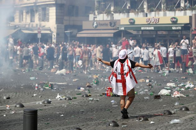 Police have confiscated the passports of hundreds of British football hooligans ahead of the World Cup; a fan wearing an England flag is pictured above during the UEFA Euro 2016 football tournament