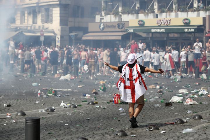 Police have confiscated the passports of hundreds of British football hooligans ahead of the World Cup; a fan wearing an England flag is pictured above during the UEFA Euro 2016 football tournament