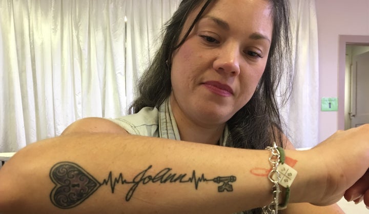 Maria Salas displays a tattoo honoring the memory of her sister, JoAnn Ward, one of 26 people killed Nov. 5 at the First Bapt