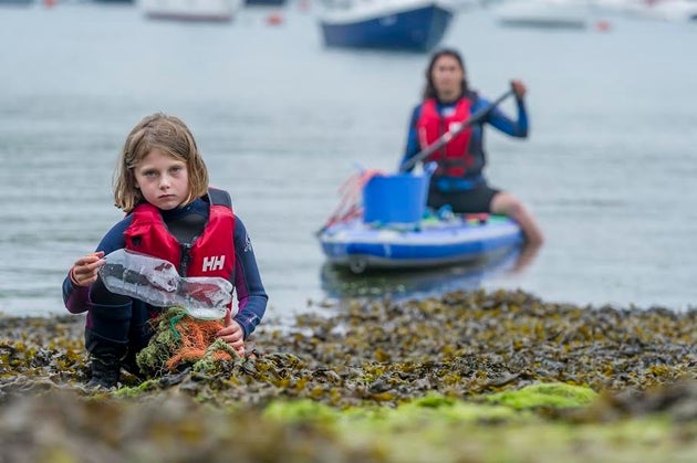 Ella collected plastic rubbish while paddleboarding in the Salcombe-Kingsbridge estuary with her mum Anna Turns.