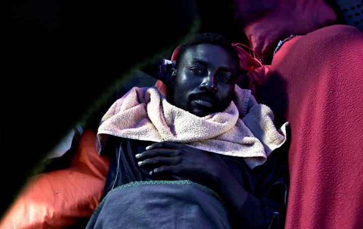 A migrant rests on the deck of the Aquarius as the vessel heads towards Spain. He and hundreds of others were turned away fro