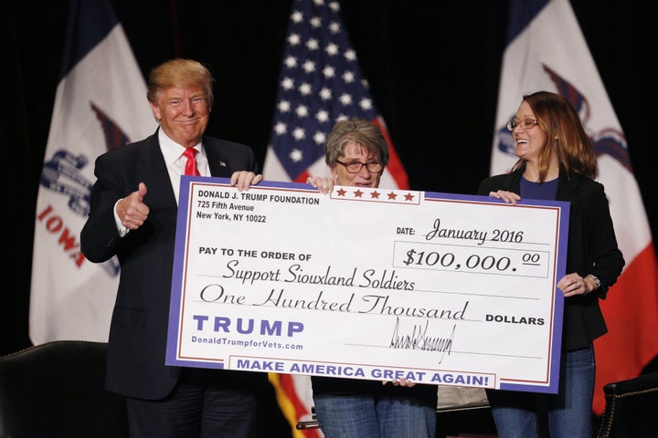 Then-presidential candidate Donald Trump awards a $100,000 check to a veterans charity during a campaign event in S