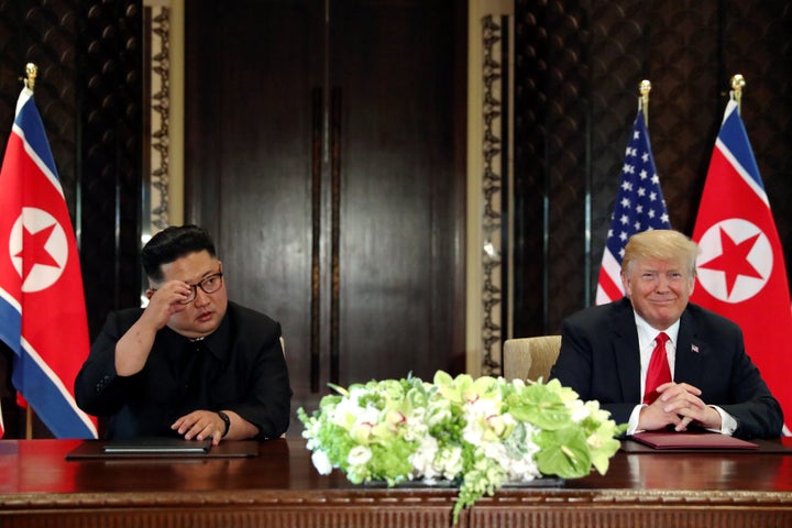 North Korean leader Kim Jong Un and President Donald Trump hold a signing ceremony at the conclusion of their summit at the Capella Hotel on the island of Sentosa, Singapore, on Tuesday.