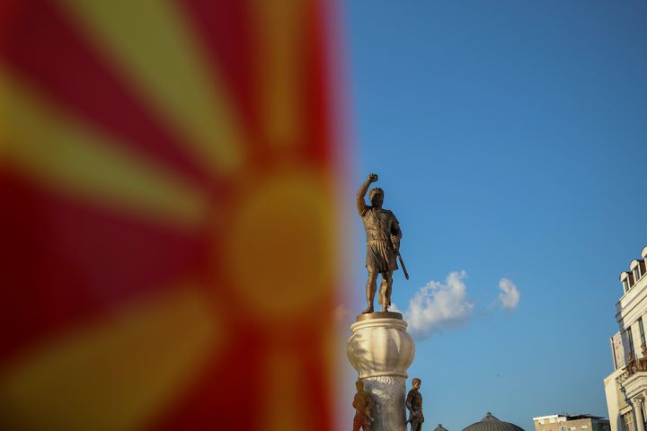 A Macedonian flag is pictured in front of the "warrior monument" in central Skopje, Macedonia, May 31, 2018. It is widely believed that the statue is a depiction of Philip of Macedon. 