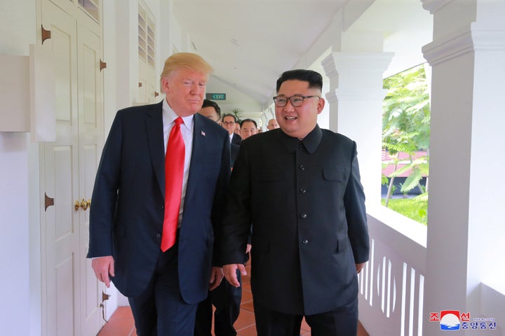 President Donald Trump walks with North Korean leader Kim Jong Un at the Capella Hotel in Singapore on June 12.