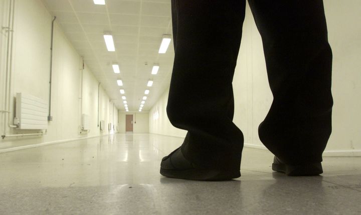 A Group 4 security officer walks down one of the corridors of Yarl's Wood Immigration Removal Centre, Europe's largest detention centre for illegal immigrants, in Bedford January 17, 2002